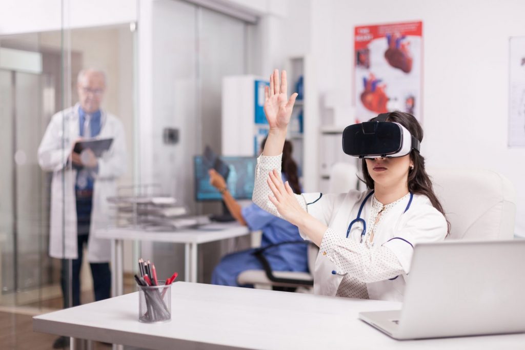 Doctor wearing high tech virtual reality goggles